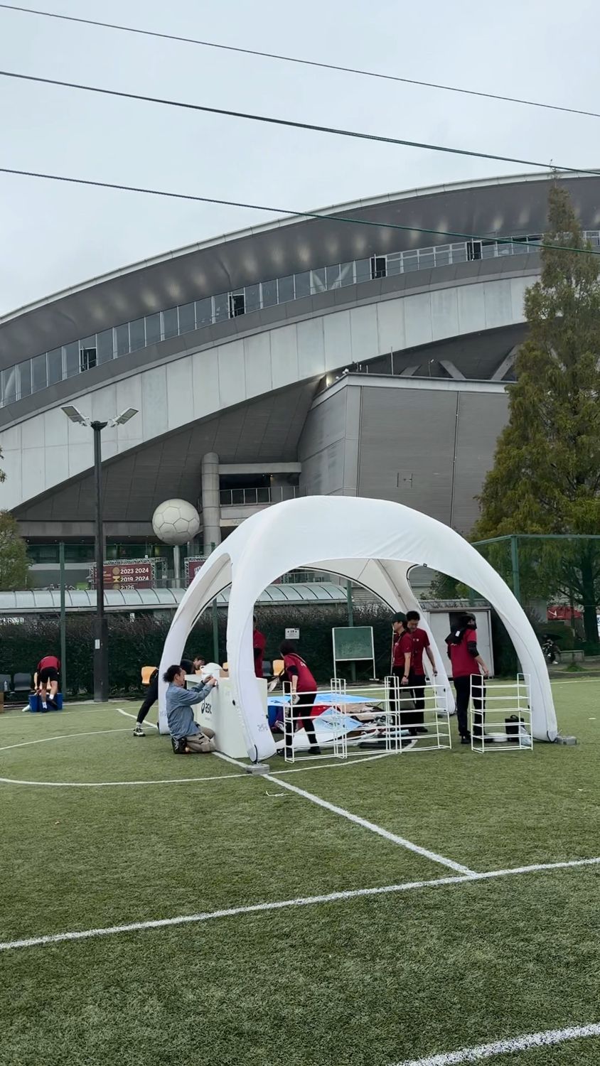 ノエビアスタジアム神戸の横にある人工芝の会場に、白いテントと柵が設営されている様子